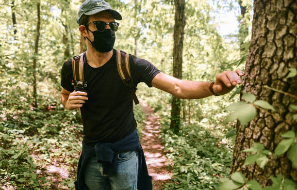 Man with a black mask doing a hike in a National park in the US. Ozark . Arkansas.